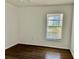 Bedroom featuring wood-look flooring, a window for natural light, and neutral-colored walls at 4208 Winding Moss Trl # 102, Tampa, FL 33613