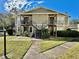 Traditional two-story apartment building featuring a staircase and well-maintained landscaping at 4208 Winding Moss Trl # 102, Tampa, FL 33613