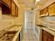 Functional kitchen featuring tile flooring, white appliances, and a sink near a faux marble countertop at 4208 Winding Moss Trl # 102, Tampa, FL 33613