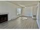 Bright living room with gray wood-look flooring, a fireplace, and a window with natural light at 4208 Winding Moss Trl # 102, Tampa, FL 33613