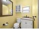 Clean bathroom with white vanity and a large mirror at 4424 W Bay Villa Ave, Tampa, FL 33611