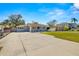 Spacious front yard with concrete driveway and well-manicured lawn at 4424 W Bay Villa Ave, Tampa, FL 33611