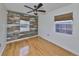 Bedroom with wood floors, accent wall, and ceiling fan at 4619 W Bay Villa Ave, Tampa, FL 33611