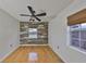 Bedroom with wood floors, accent wall, and ceiling fan at 4619 W Bay Villa Ave, Tampa, FL 33611