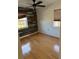 Bedroom with wood-look floors and a rustic accent wall at 4619 W Bay Villa Ave, Tampa, FL 33611