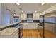 Modern kitchen with white cabinets and stainless steel appliances at 4619 W Bay Villa Ave, Tampa, FL 33611