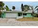 Charming light green ranch house with a single car garage at 4919 Shore Acres Ne Blvd, St Petersburg, FL 33703