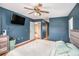 Main bedroom with wood floors, a ceiling fan, and access to a hallway at 5004 Osprey Ln, New Port Richey, FL 34652