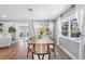 Dining area with wooden table, view into living room and pool at 5105 W Country Club Dr, Sarasota, FL 34243