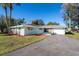 Charming light-blue single-story home with a spacious driveway at 5105 W Country Club Dr, Sarasota, FL 34243