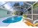 Inviting pool area with screened enclosure and lounge chair at 5105 W Country Club Dr, Sarasota, FL 34243