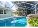 Inviting swimming pool with screened enclosure and lounge chairs at 5105 W Country Club Dr, Sarasota, FL 34243