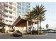 Modern building entrance with covered carport and palm trees at 5120 Marina Way # 21406, Tampa, FL 33611