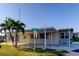 Tan single-story home with carport and palm trees in front at 544 Skipper Dr # 544, Seminole, FL 33772