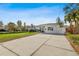 Front view of a charming single-story house with a spacious driveway at 5934 Bayou Grande Ne Blvd, St Petersburg, FL 33703