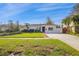 White single story home with palm trees and a manicured lawn at 5934 Bayou Grande Ne Blvd, St Petersburg, FL 33703