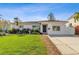 White single-story home with a lush green lawn and a driveway at 5934 Bayou Grande Ne Blvd, St Petersburg, FL 33703