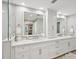 Spa-like bathroom with double vanity, large mirror, and updated finishes at 595 5Th Ne Ave, St Petersburg, FL 33701