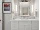 White bathroom vanity with large mirror and modern light fixtures at 595 5Th Ne Ave, St Petersburg, FL 33701