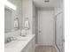 Clean bathroom with white vanity, a large mirror, and walk-in shower at 595 5Th Ne Ave, St Petersburg, FL 33701