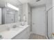 Clean bathroom with white vanity, a large mirror, and walk-in shower at 595 5Th Ne Ave, St Petersburg, FL 33701