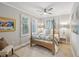 Guest bedroom with a four-poster bed and plantation shutters at 595 5Th Ne Ave, St Petersburg, FL 33701