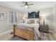 Bright bedroom with wood bed frame, light walls, and window with shutters at 595 5Th Ne Ave, St Petersburg, FL 33701