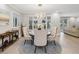 Elegant dining room features a round table with four chairs, large windows, and hardwood floors at 595 5Th Ne Ave, St Petersburg, FL 33701