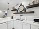 Modern white kitchen with stainless steel appliances and decorative shelving at 595 5Th Ne Ave, St Petersburg, FL 33701