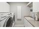 Laundry room with washer, dryer, and a utility sink at 595 5Th Ne Ave, St Petersburg, FL 33701