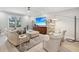 Bright living room with comfy seating, large TV, and hardwood floors at 595 5Th Ne Ave, St Petersburg, FL 33701