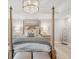 Serene main bedroom with a four poster bed and elegant chandelier at 595 5Th Ne Ave, St Petersburg, FL 33701