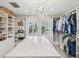 Luxurious walk-in closet with island, custom shelving, and chandelier at 595 5Th Ne Ave, St Petersburg, FL 33701