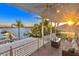 Covered balcony with comfortable seating and stunning sunset views at 644 Boca Ciega Isle Dr, St Pete Beach, FL 33706