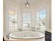 Bathroom with large corner jacuzzi tub and water views at 644 Boca Ciega Isle Dr, St Pete Beach, FL 33706