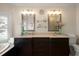 Double vanity bathroom with dark brown cabinets and large mirrors at 644 Boca Ciega Isle Dr, St Pete Beach, FL 33706