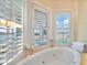 Bathroom with large corner jacuzzi tub and water views at 644 Boca Ciega Isle Dr, St Pete Beach, FL 33706