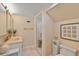 Clean bathroom with marble shower, double vanity, and updated fixtures at 644 Boca Ciega Isle Dr, St Pete Beach, FL 33706