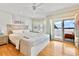 Main bedroom with water views, king-size bed, and wood floors at 644 Boca Ciega Isle Dr, St Pete Beach, FL 33706