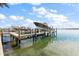 Private boat dock with covered slips for multiple vessels at 644 Boca Ciega Isle Dr, St Pete Beach, FL 33706