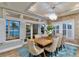 Elegant dining room with a rustic wood table and water views at 644 Boca Ciega Isle Dr, St Pete Beach, FL 33706