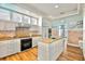 Bright kitchen featuring granite countertops, white cabinetry, and modern appliances at 644 Boca Ciega Isle Dr, St Pete Beach, FL 33706