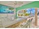 Waterfront outdoor bar with seating and tropical view at 644 Boca Ciega Isle Dr, St Pete Beach, FL 33706