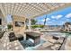 Relaxing poolside patio with pergola and seating at 644 Boca Ciega Isle Dr, St Pete Beach, FL 33706