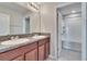 Double vanity bathroom with granite countertop and wood cabinets at 6834 Blue Moon Way, Sun City Center, FL 33573