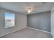 Bright bedroom with window, neutral walls, and ceiling fan at 6834 Blue Moon Way, Sun City Center, FL 33573