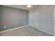 Spacious bedroom with gray accent wall and ceiling fan at 6834 Blue Moon Way, Sun City Center, FL 33573