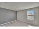 Bright bedroom with gray accent wall and window at 6834 Blue Moon Way, Sun City Center, FL 33573