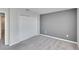 Bedroom with double door closet and gray accent wall at 6834 Blue Moon Way, Sun City Center, FL 33573