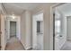 Well-lit hallway with neutral walls and carpet flooring at 6834 Blue Moon Way, Sun City Center, FL 33573